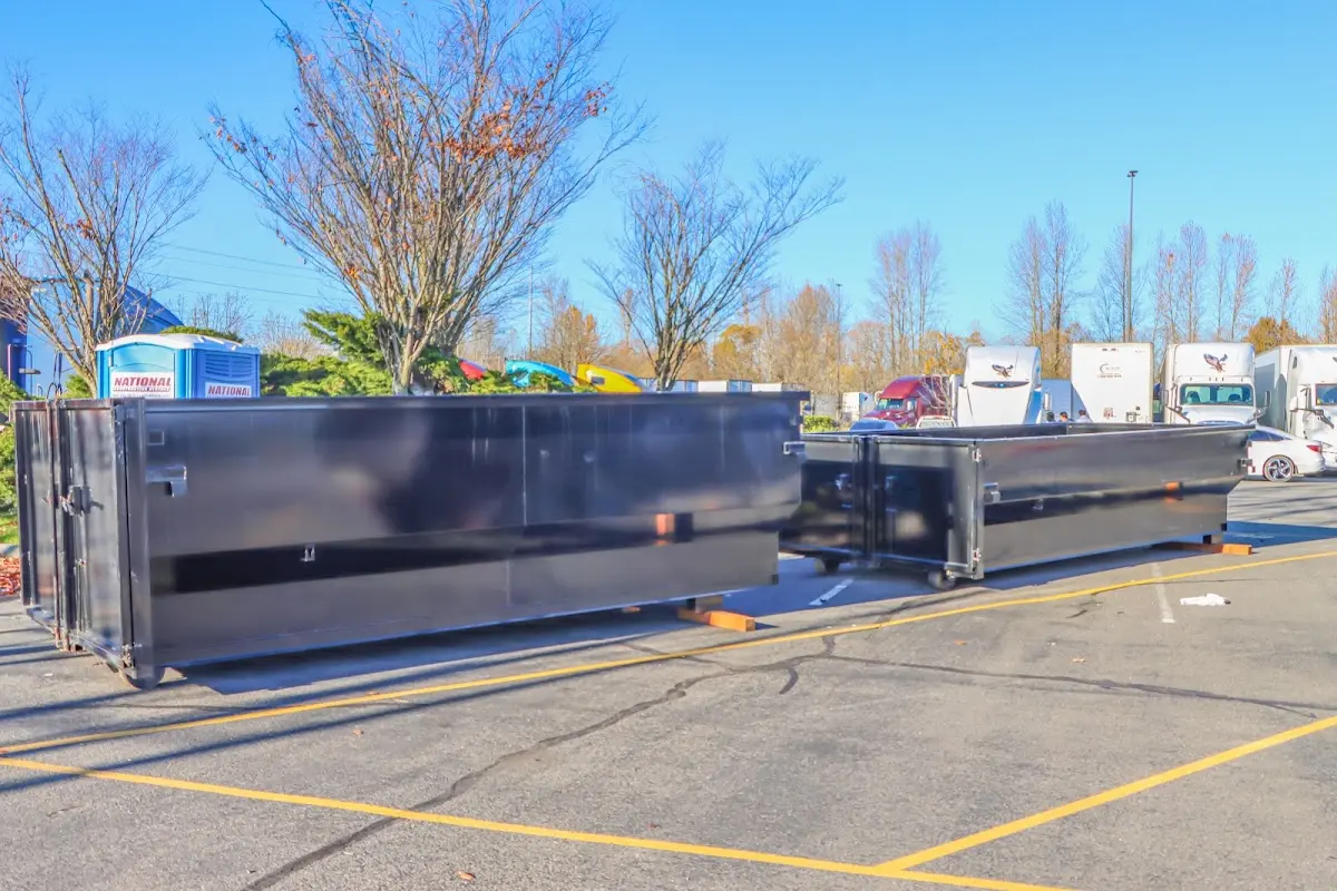 Professional dumpster rental service with roll-off container on residential driveway in South Elgin